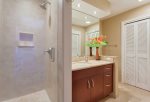 The guest bathroom features a shower, sink and washer and dryer
